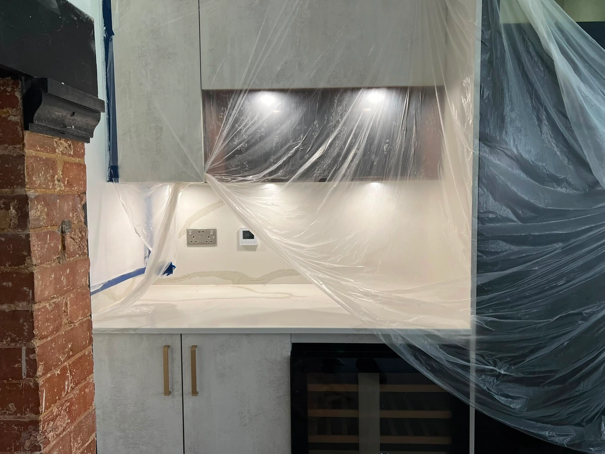 Under-cabinet lights, socket and grid switch above a worktop