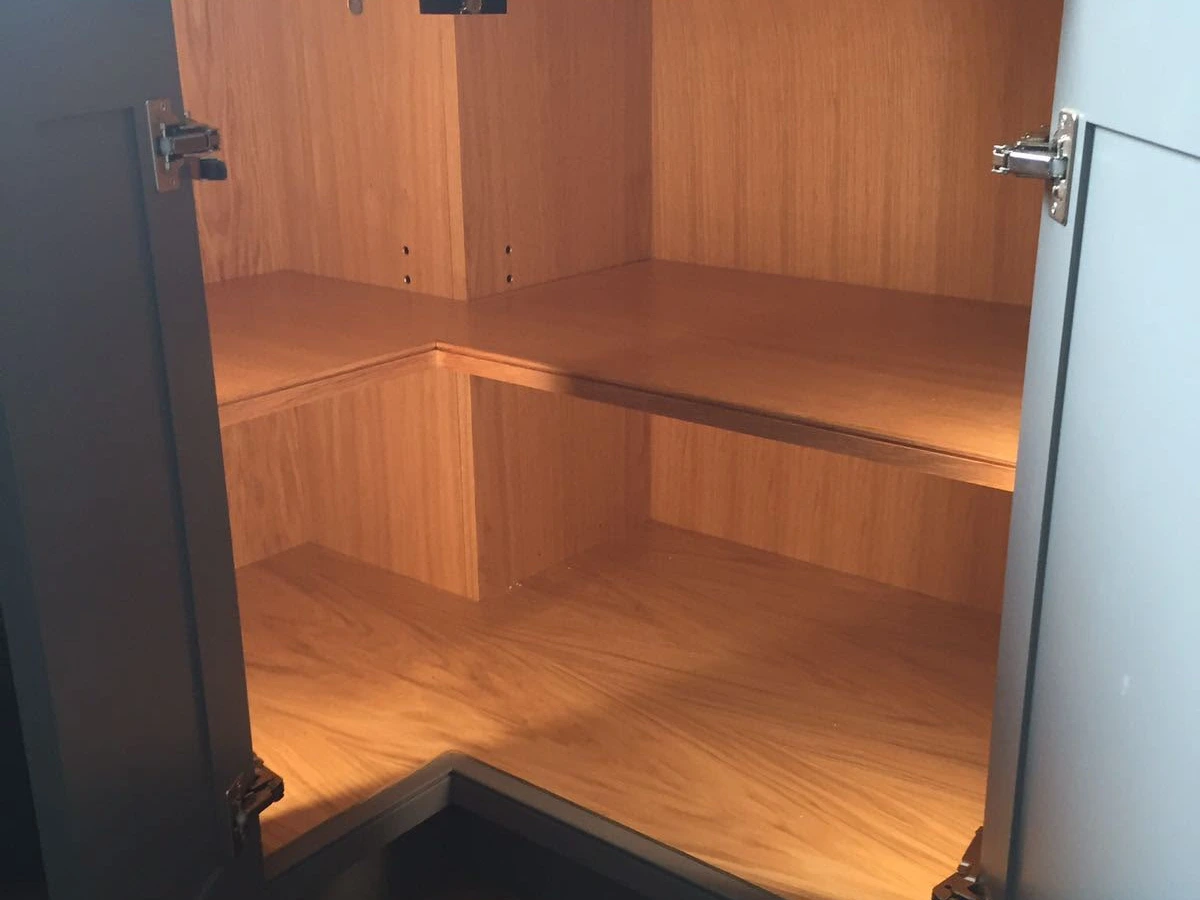 Warm strip lighting inside a corner kitchen cupboard