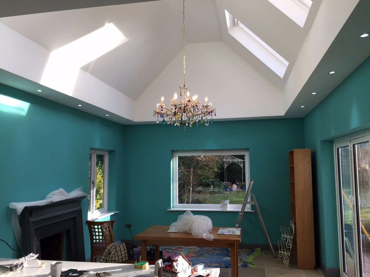 Downlights and a chandelier in a vaulted ceiling