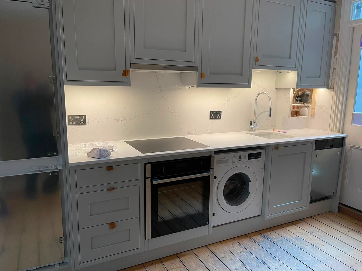 Sockets and under-unit lighting in a fitted shaker kitchen